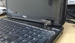 Image of Dell laptop with broken right hand hinge.